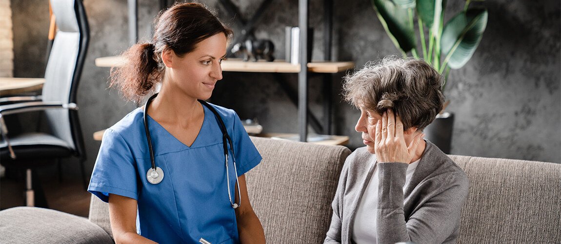 A caregiver listening closely to a client