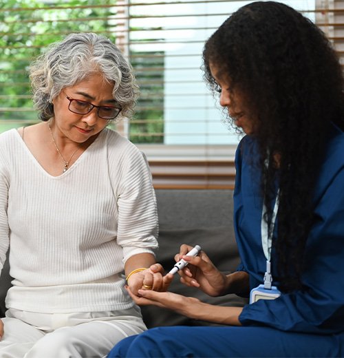 A caregiver helping a client with daily medication monitoring